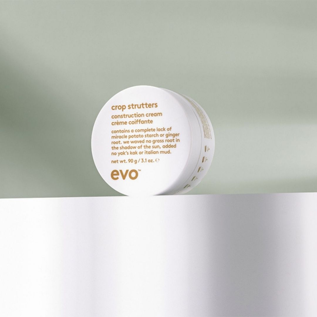 Evo crop strutters construction cream jar on a light green and white background