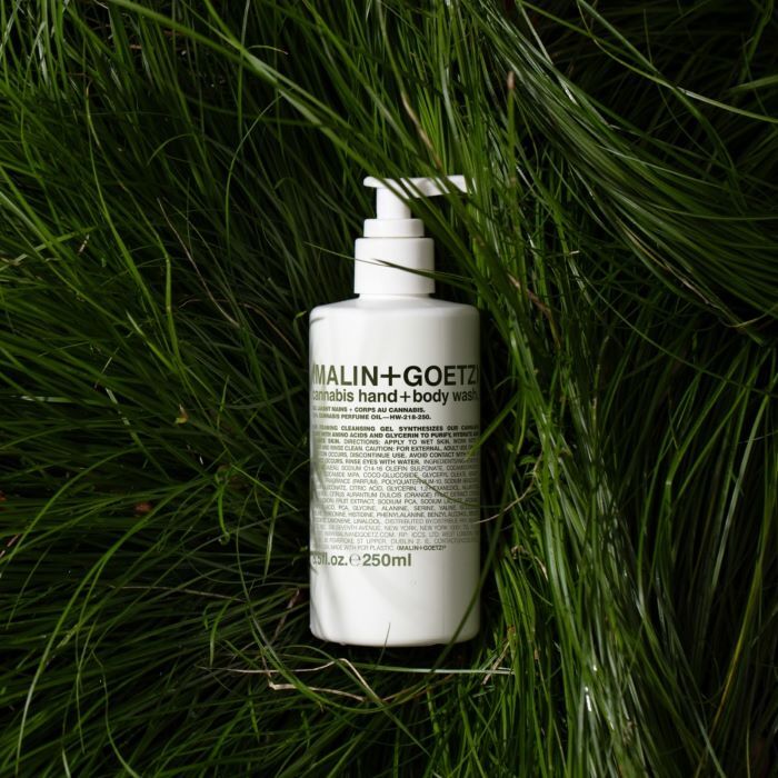 Malin+Goetz bottle of hand and body wash on grass