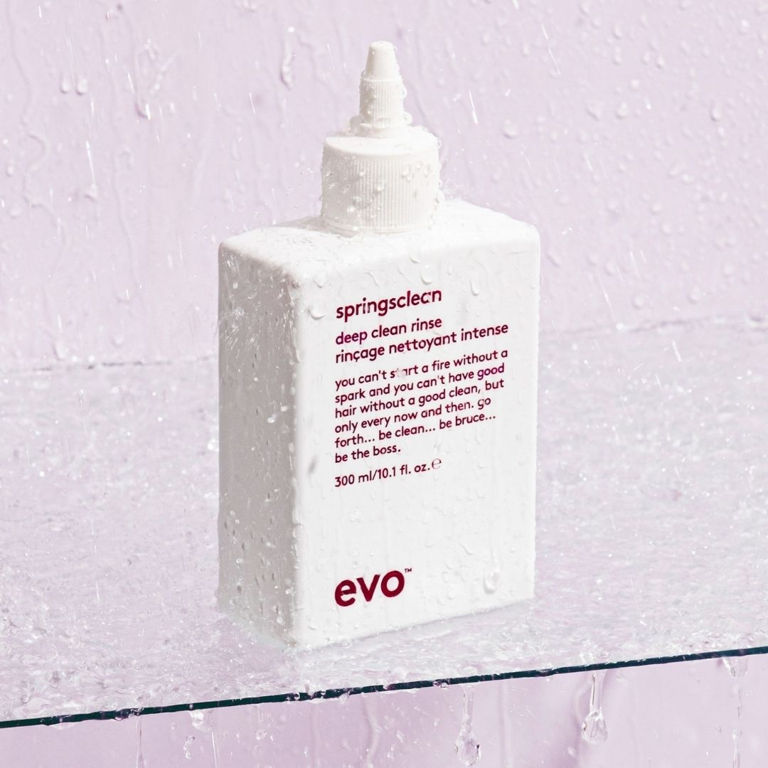 Bottle of evo springscleen deep clean rinse on a textured light purple background