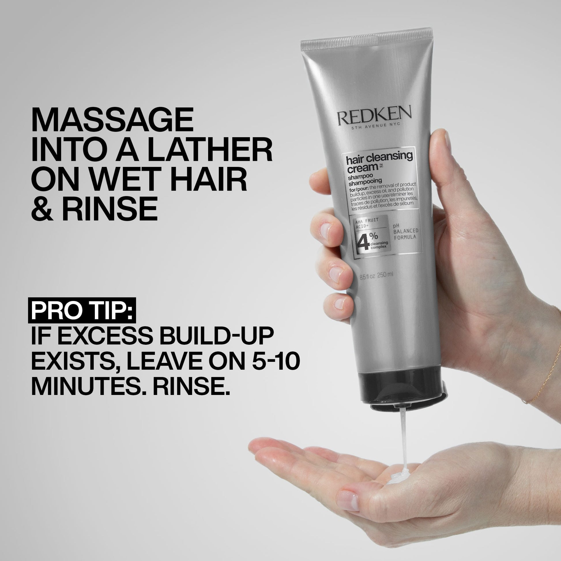 Redken hair cleansing cream tube being held with instructions on application.