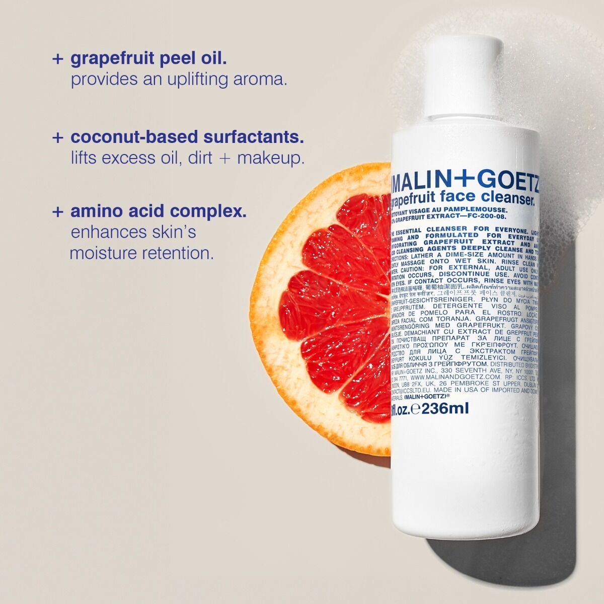 Malin+Goetz face cleanser bottle with grapefruit and text on a beige background