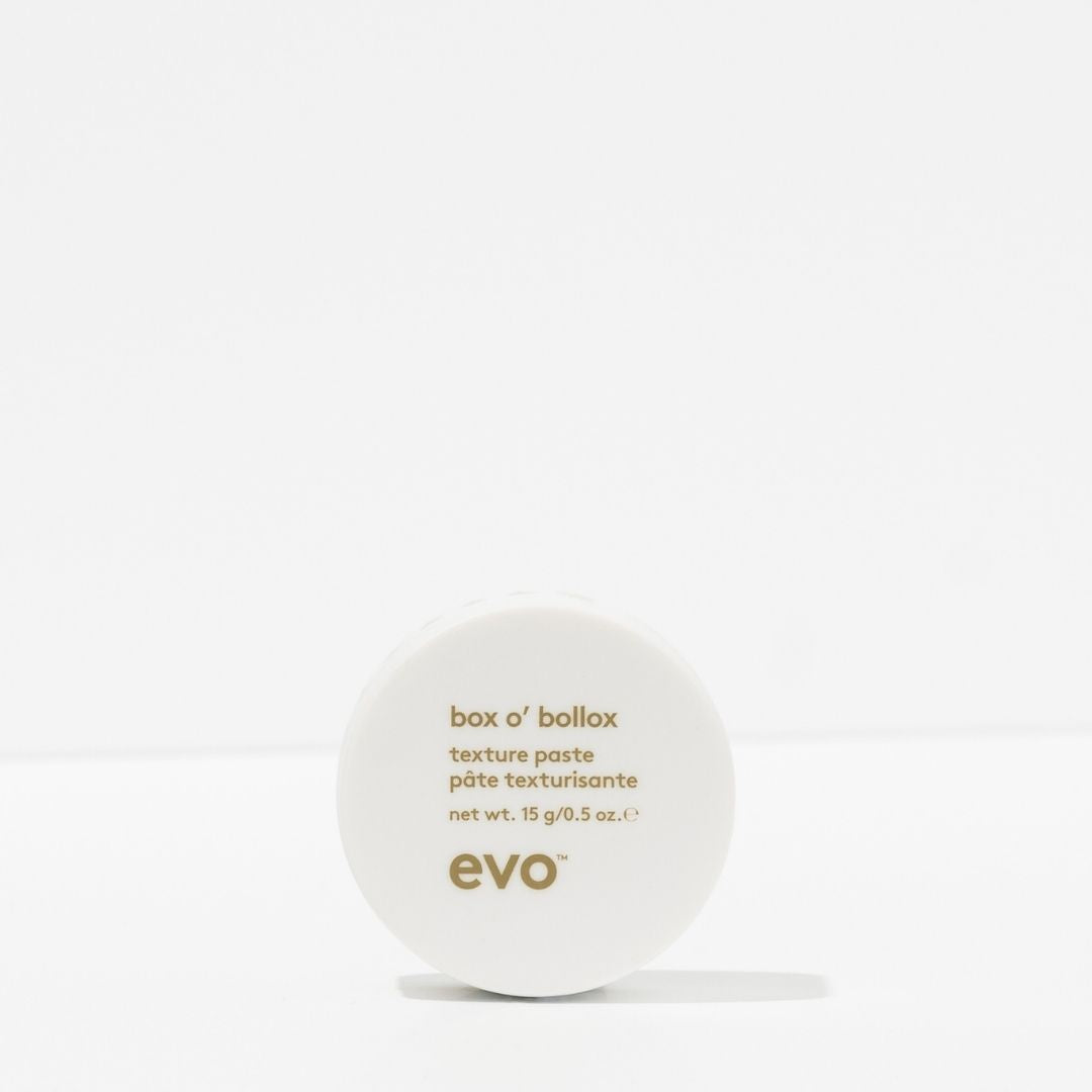White container of evo box o' bollox texture paste on a white background