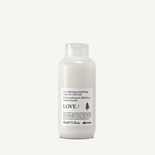 Bottle of Davines Love Curl Cream on a white background