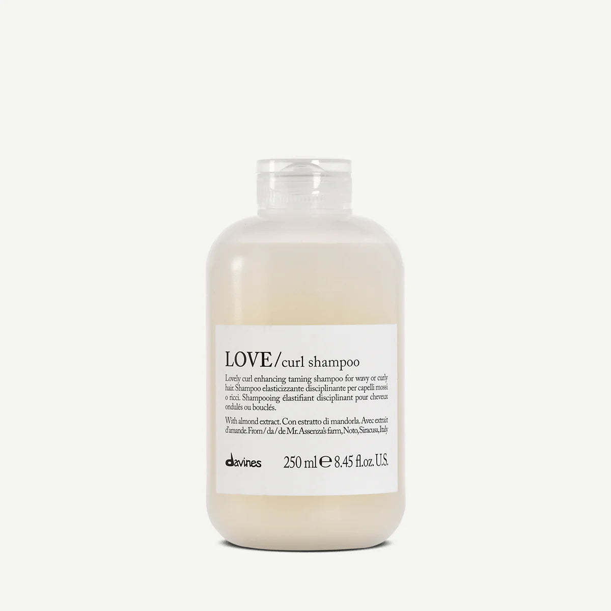 Bottle of Davines LOVE/curl shampoo on a white background