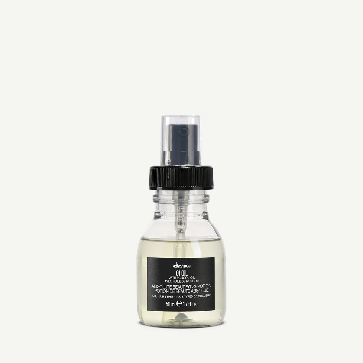 Travel-sized bottle of Davines OI Oil on a white background