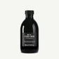 Black bottle of Davines OI Body Wash on a white background