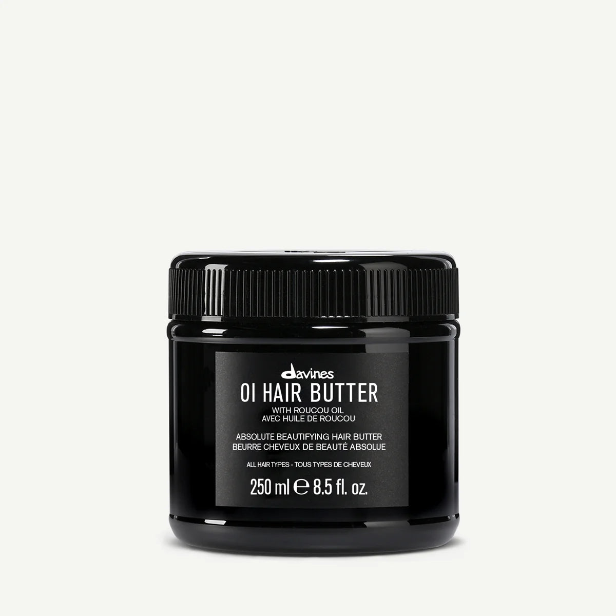 Black jar of Davines OI Hair Butter on a white background