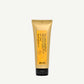 Yellow tube of Davines hair product on a white background