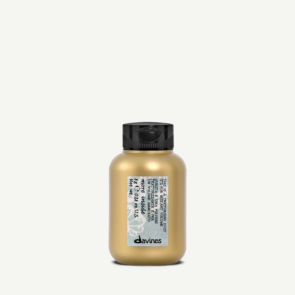 Gold hair product bottle with black cap on a white background