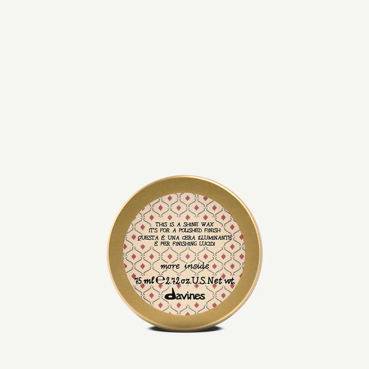 Gold container of glossy styling wax with decorative lid and text on a white background