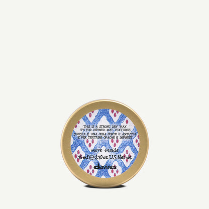 Container of Davines Strong Dry Wax with a colourful label on a white background