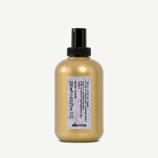 Gold bottle with black cap and label on a white background