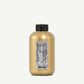 Gold hair product bottle with black cap on a white background
