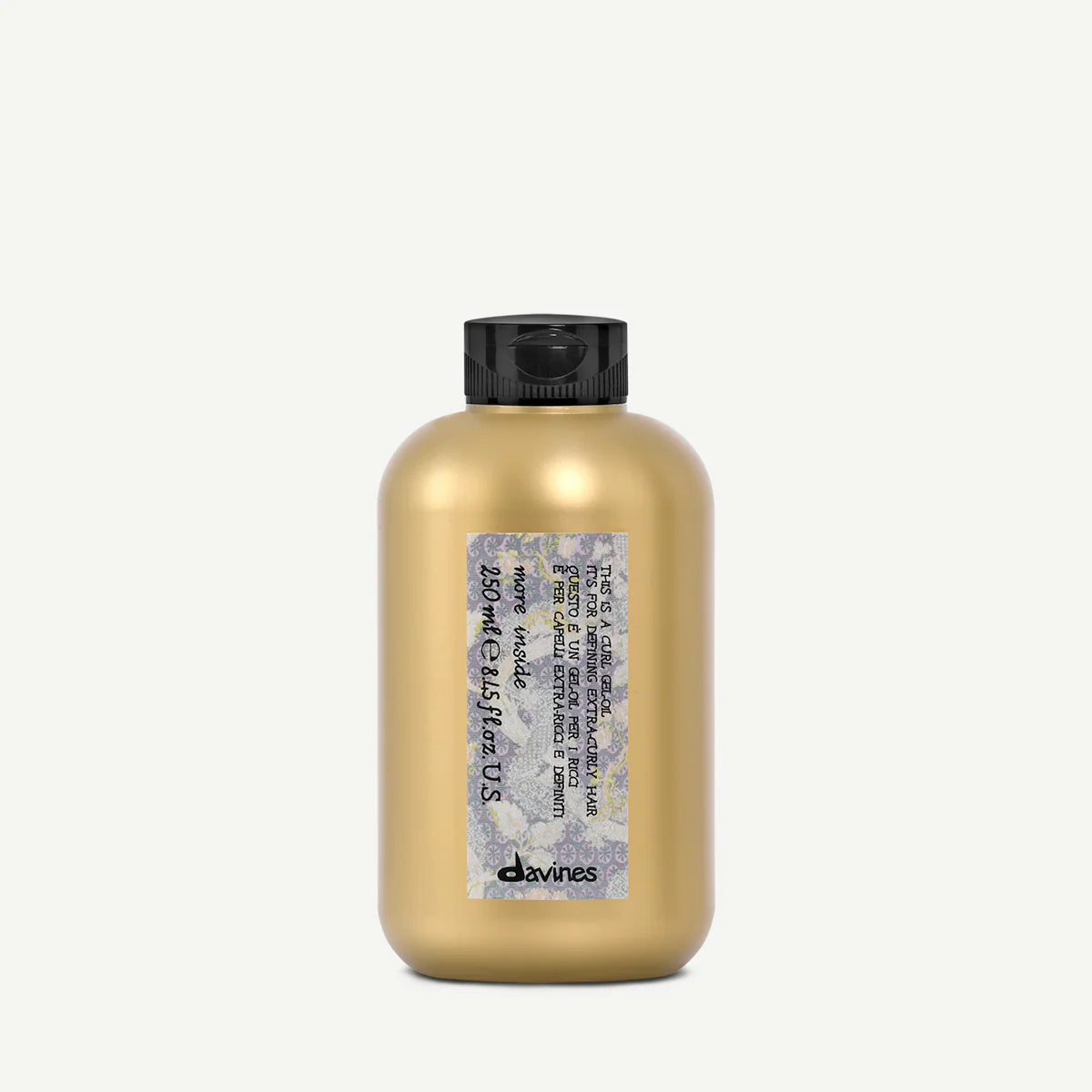Gold hair product bottle with black cap on a white background