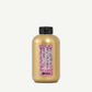 Gold bottle with pink label on a white background