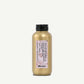 Gold bottle of Davines Texturizing Hair Serum against white background