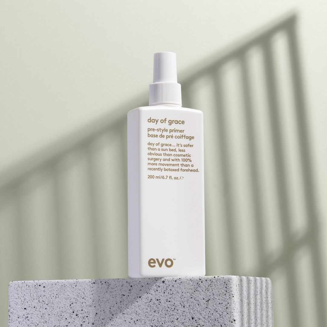 Evo 'day of grace' pre-style primer bottle on a concrete block with a neutral background