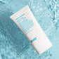 Tube of Head Mistress Cuticle Sealer against clear blue liquid background