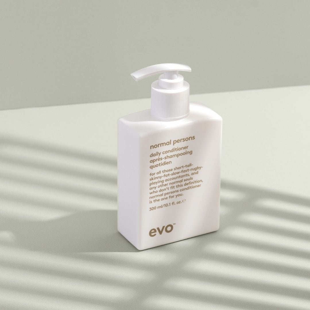 Evo daily conditioner bottle on a light surface with soft shadows