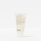 Small white container of 'normal persons' shampoo with gold text on a white background