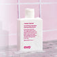 Shampoo bottle labeled 'mane tamer' on a pink tiled background