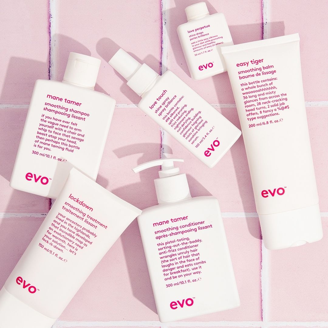 Collection of Evo hair care products on a pink background