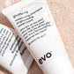 Two tubes of evo volumising shampoo on a textured beige background