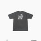 Back of dark grey t-shirt against white background; GOAT logo in lower left corner, Harvey Nichol Studio logo in lower right corner