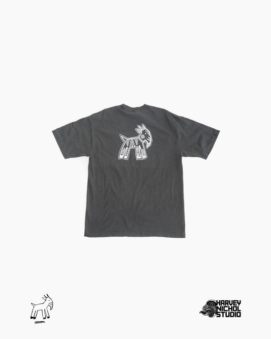 Back of dark grey t-shirt against white background; GOAT logo in lower left corner, Harvey Nichol Studio logo in lower right corner