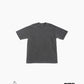 Front of dark grey t-shirt against white background; GOAT logo in lower left corner, Harvey Nichol Studio logo in lower right corner