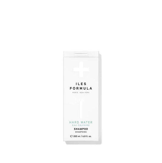 Shampoo bottle with 'ILES FORMULA' branding on a white background