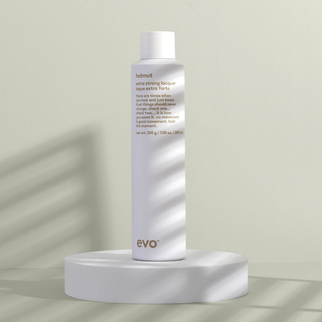 Evo hair product bottle on a white platform with a light background