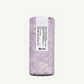 Bottle wrapped in lilac packaging on a white background