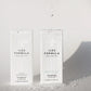 Two bottles of Iles Formula shampoo on a textured white surface.