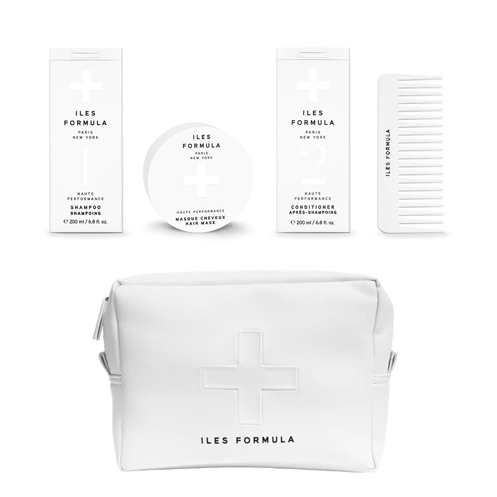 ILES FORMULA hair care products including a vegan leather beauty bag on a white background