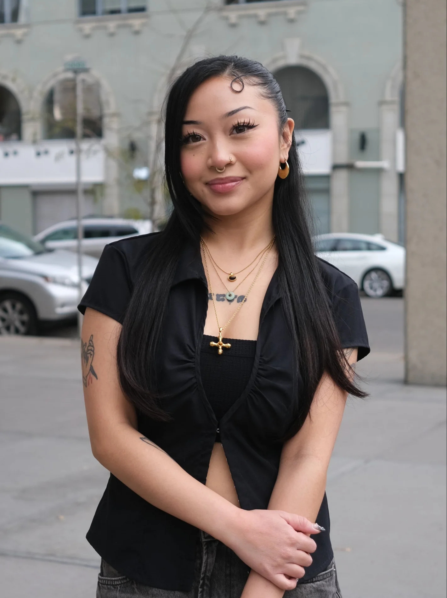 Kayla in a black top at the corner of GOAT's street