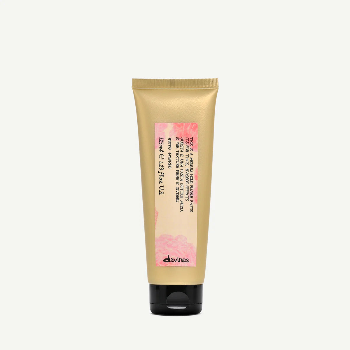 Gold tube of Davines Medium Hold Pliable Paste with pink label on a white background