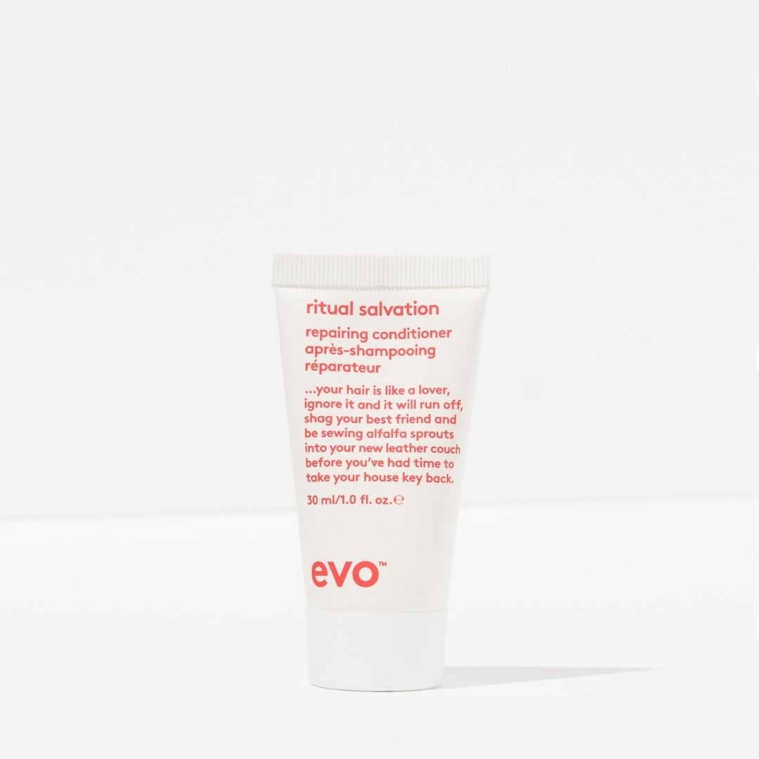 White bottle of evo ritual salvation repairing conditioner with red text on a white background
