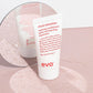 Evo 'ritual salvation' repairing conditioner tube on a pink textured surface