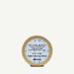 Small gold container with a blue label on a white background