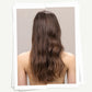 Split photo showing before and after using Volume Boosting Mousse on long, wavy brown hair on a neutral background