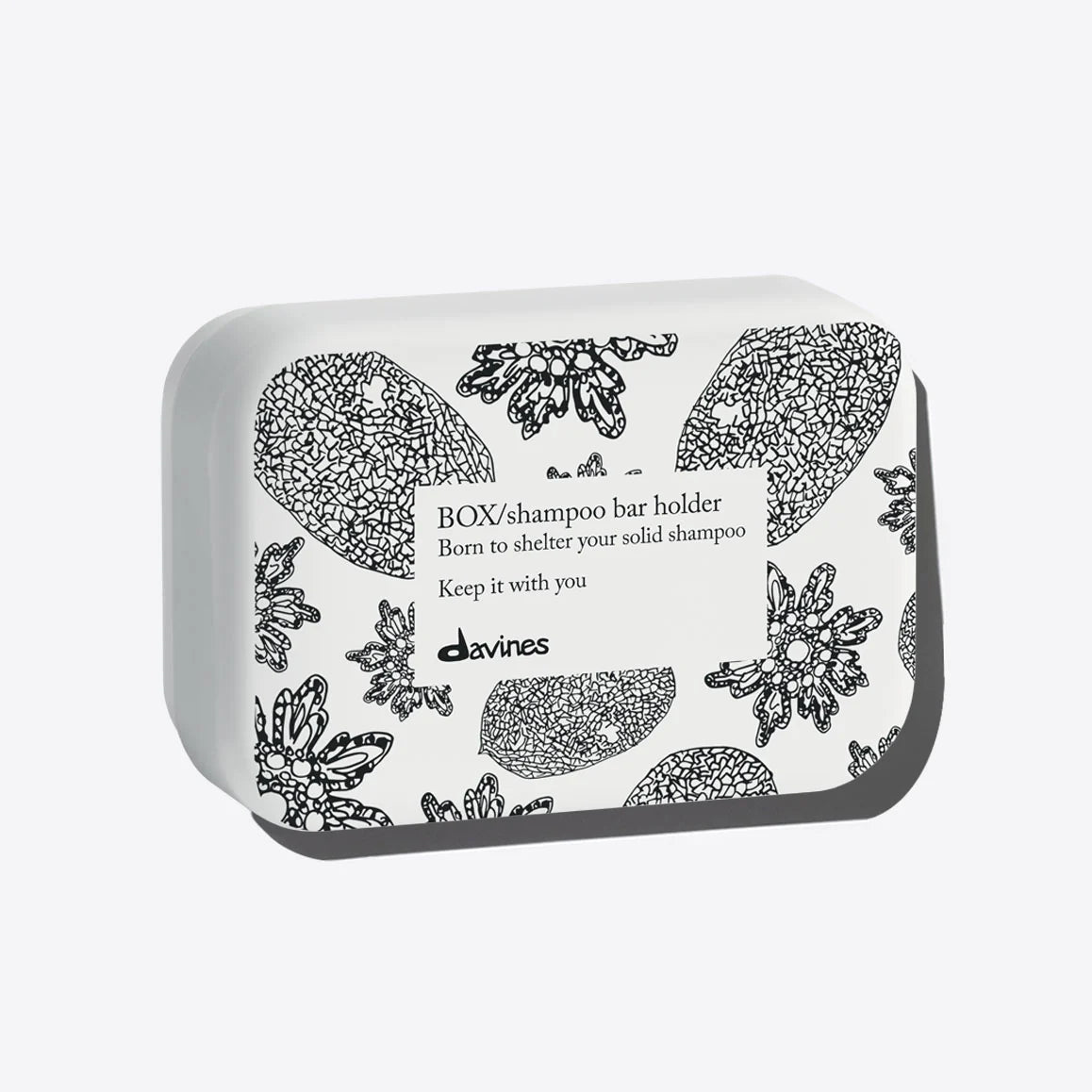 Davines shampoo bar holder with floral designs on a white background