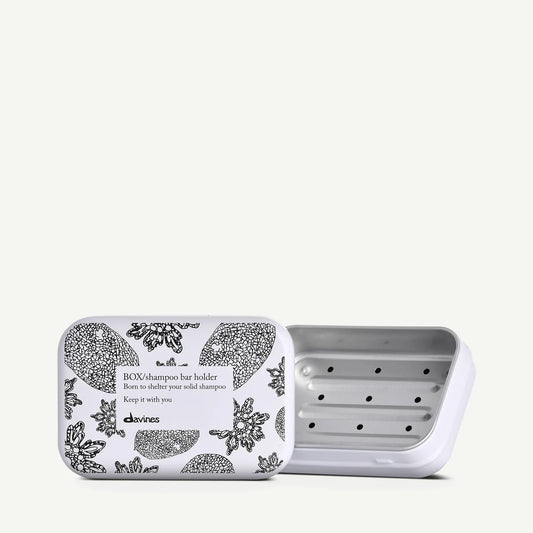 Open Davines shampoo bar holder with floral design on a white background