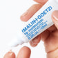 Hand holding a MALIN+GOETZ lip moisturizer tube with a white background