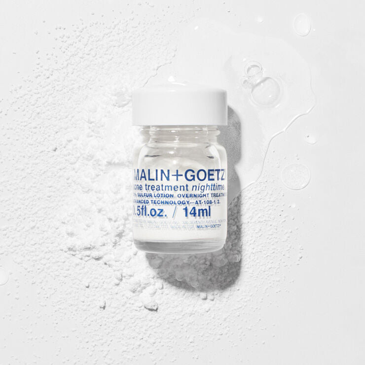 Malin+Goetz skincare treatment bottle on a textured white background