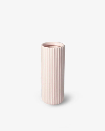 A tall, cylindrical, pinkish-coloured ceramic vase with a subtle rim inside, placed against a white background.